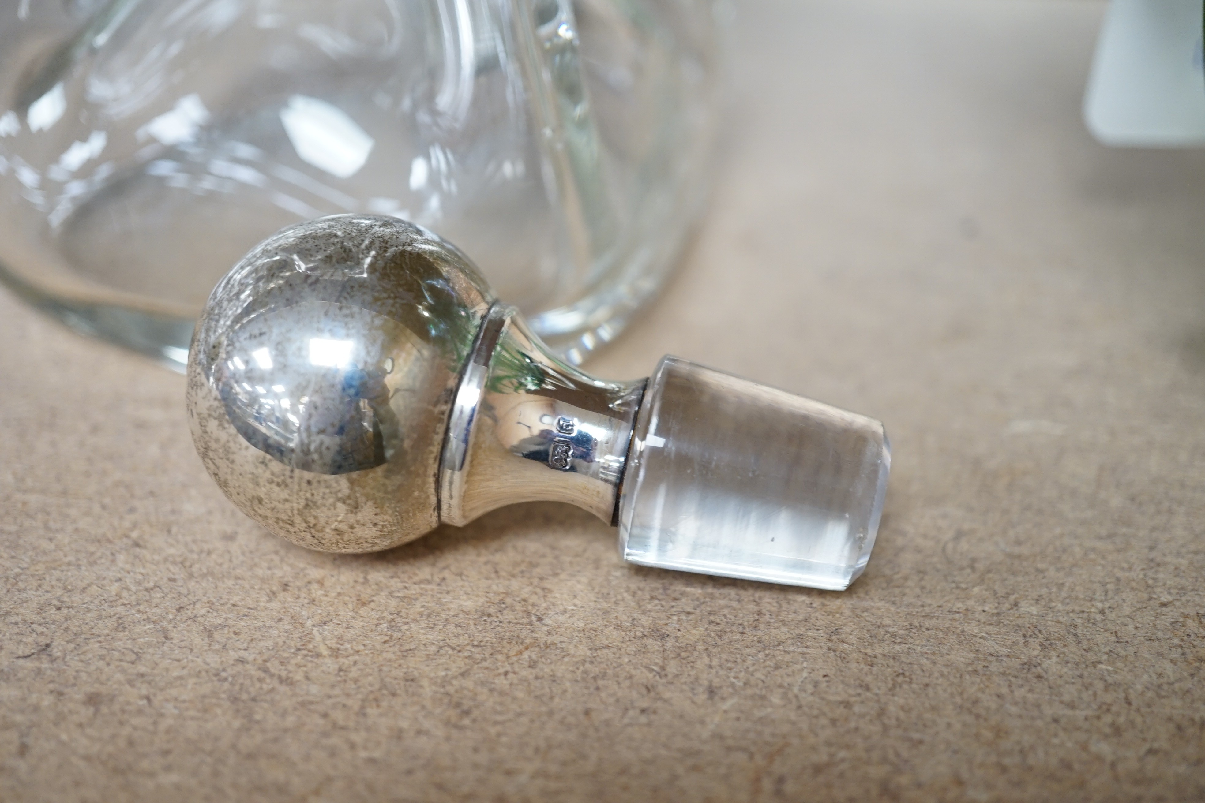 A late Victorian Art Nouveau silver mounted glass claret jug and stopper, D & M Davis, Birmingham, 1900, the glass with ribbed green swags, height 20.7cm.